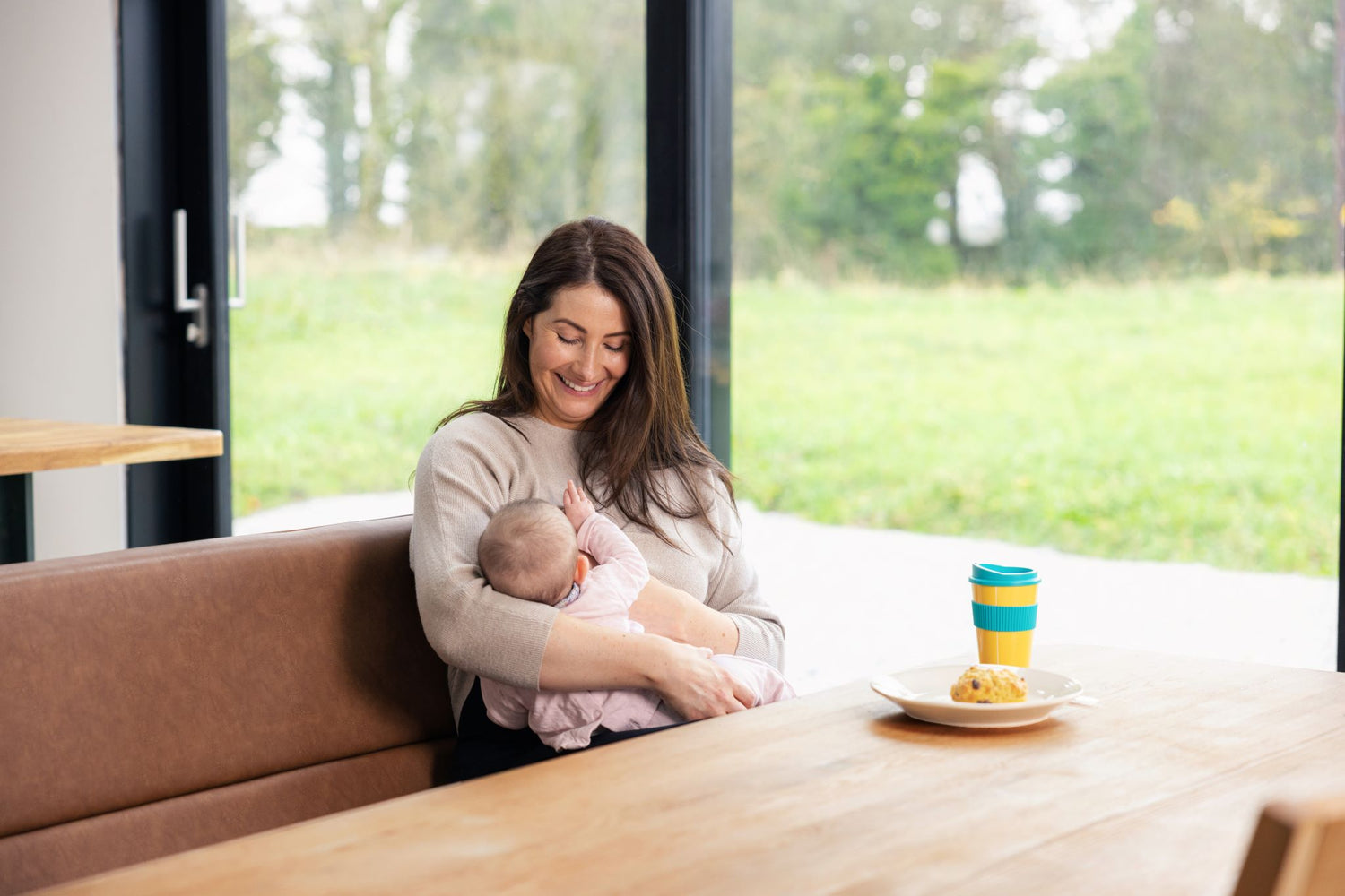 Mum Breastfeeding Baby whilst drinking tea