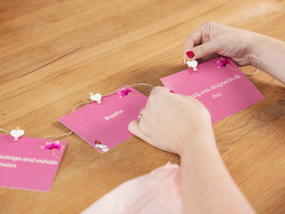 Birth Affirmation Cards displayed on string by a mum