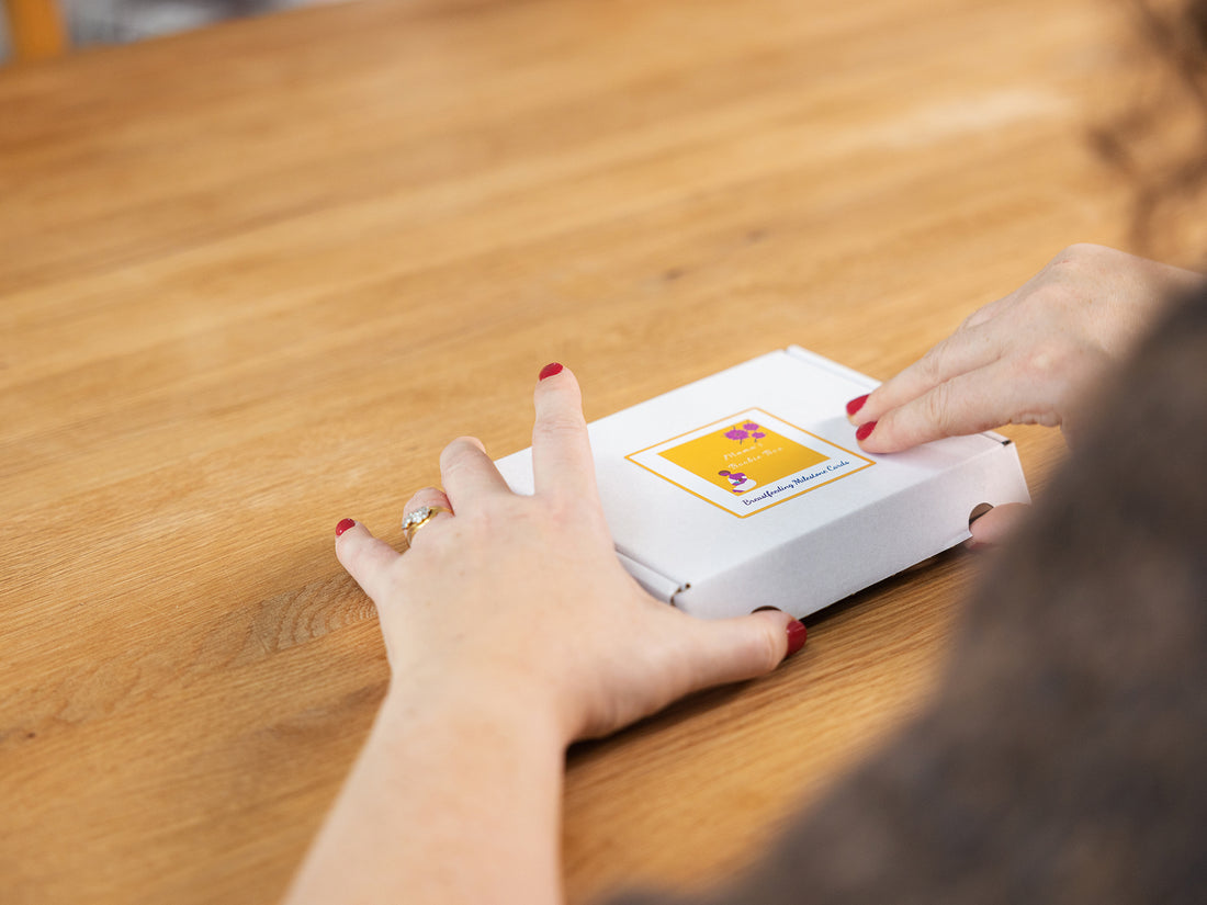 Breastfeeding Milestone Cards being opened by a mum