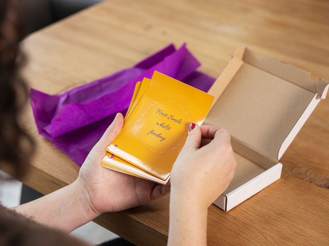 Breastfeeding Milestone Cards being read by a mum