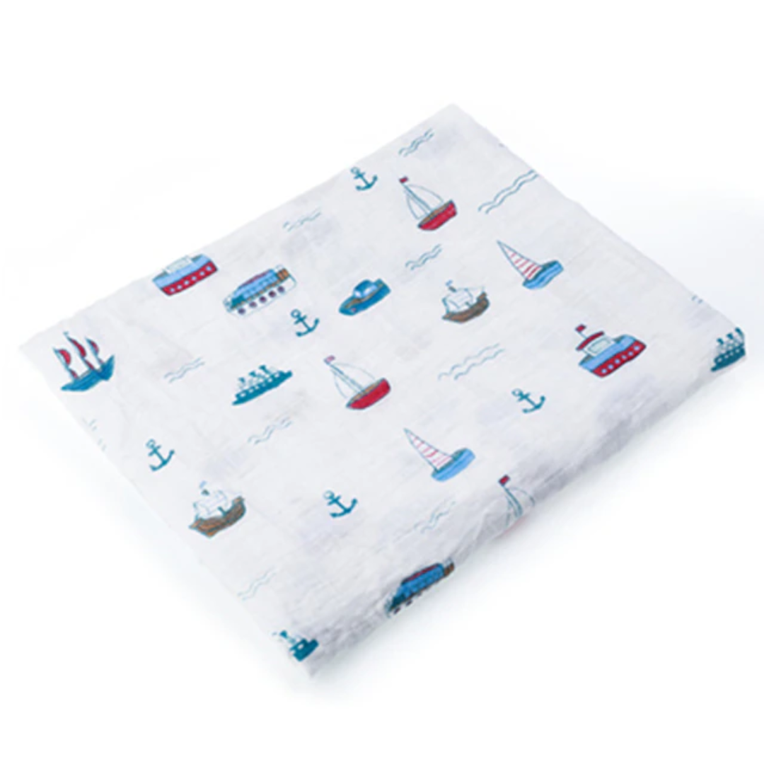 Swaddle Muslin for a baby in a pattern of sail boats, made from cotton.
