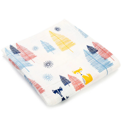 Swaddle Muslin for a baby in a pattern of foxes and trees, made from cotton.
