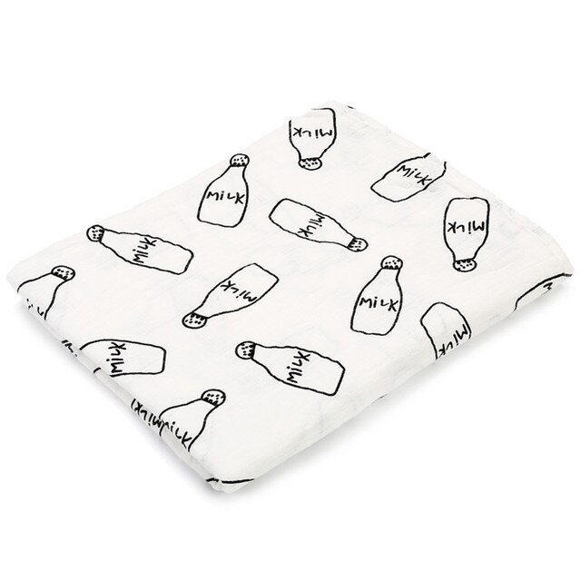 Swaddle Muslin for a baby in a pattern of milk bottles, made from cotton.